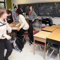 Emily Poole, left, moves to lock and cover the classroom door Wednesday as her third-period class mo...