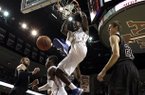 Florida's Patric Young (4) dunks the ball as Texas A&M's Alex Caruso (21) watches during the second half of an NCAA college basketball game on Thursday, Jan. 17, 2013, in College Station, Texas. Florida defeated Texas A&M 68-47. (AP Photo/David J. Phillip)