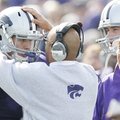 Wide receivers coach Michael Smith talks with Kansas State quarterback Grant Gregory on the sideline...