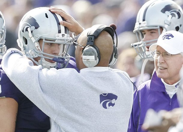 wide-receivers-coach-michael-smith-talks-with-kansas-state-quarterback-grant-gregory-on-the-sideline-during-a-2009-game-against-colorado