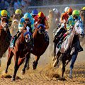 Horses race through the turn during the ÿrst race Thursday at Oaklawn Park in Hot Springs. It was th...