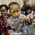 Jesse Henderson, 18 months, of Centerton plays with a swarm of bubbles Thursday blown by library ass...