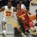 Arkansas' B.J. Young (11) dribbles past Ole Miss' Nick Williams (20) in Oxford, Miss., on Saturday, ...