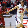 Mississippi's Marshall Henderson (22) drives against Arkansas' Fred Gulley (12) during an NCAA colle...