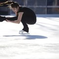 Julia Ludena Zumbach of Springdale performs a “sit spin” as part of her routine Saturday during an e...