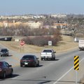 Traffic travels Thursday along North College Avenue in Fayetteville past a portion of the roadway th...