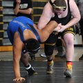 Jared Conover  of Bentonville attempts to flip Rogers High’s Josue Oscoy on Saturday at Bentonville ...