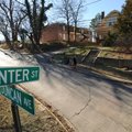 A pedestrian walks north Wednesday on Duncan Avenue to Center Street in Fayetteville past a house an...