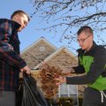 Zach Arrick, 16, left, holds a trash bag open as Cullen Arrick, 18, fills it with fallen gumballs fr...