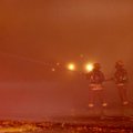 A pair of Springdale firefighters pour water onto hot spots Sunday, Jan. 20, 2013 at a fire at an ab...