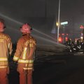 Springdale fire chief Mike Irwin, right, and Division Chief Jim Vaughan watch as firefighters respon...