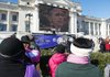 Spectators gather in front of the Arkansas State Capitol to watch President Barack Obama’s ceremonial inauguration, which was supposed to be broadcast live on a jumbo TV monitor. Technical problems delayed the broadcast by at least 10 minutes. 