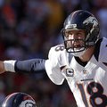 Denver Broncos quarterback Peyton Manning calls a play during the first half of an NFL football game...