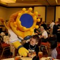 Lucas McDaniel, 10, of Springdale tries to keep Sluggerrr, the Kansas City Royals mascot, out of his...