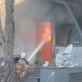 Terry Whiteside, battalion chief, hoses down flames inside a home on Marazion Drive in Bella Vista o...