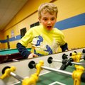 Ethan Enlow, 8, of Bentonville plays table soccer with friends Monday inside the Boys & Girls Club i...