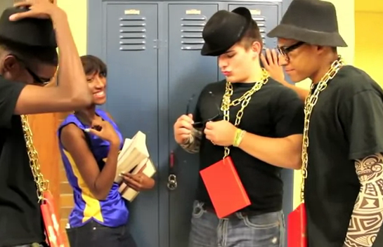 a-screen-grab-from-a-north-little-rock-high-school-video-promoting-literacy-shows-students-wearing-books-on-gold-chains-around-their-necks