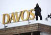 An armed police officer stands on the snow-covered rooftop of the Hotel Davos and looks out over the Congress Center, the venue for the World Economic Forum (WEF) in Davos, Switzerland, on Tuesday, Jan. 22, 2013. World leaders, Influential executives, bankers and policy makers arrive in the Swiss Alps for the 43rd annual meeting of the World Economic Forum in Davos, the five day event runs from Jan. 23-27. Photographer: Jason Alden/Bloomberg