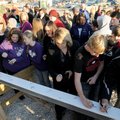 Parents, students and employees of the Elkins School District sign a steel beam Tuesday at a ceremon...