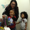 Kenneth Davis, 3, plays with one of the gifts he received Tuesday for being the 100,000th patient at...