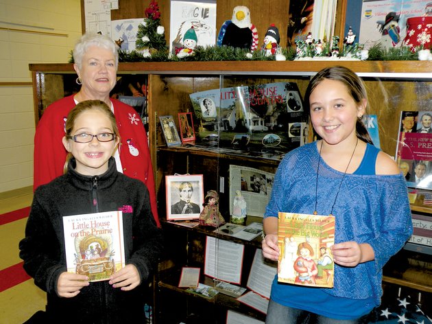 taking-a-look-at-some-of-the-items-honoring-american-author-laura-ingalls-wilder-are-in-the-back-carolyn-frazier-a-retired-second-grade-teacher-who-taught-at-vilonia-elementary-school-and-one-of-the-organizers-of-the-display-at-the-schools-library-and-front-from-the-left-evy-mckissack-and-janie-gentry-fourth-graders-at-the-elementary-school-and-readers-of-wilders-little-house-books