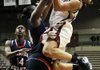 UALR junior guard Taylor Ford (right) shoots over Florida Atlantic defenders Latavia Dempsey (left) and Shanequa Schrouder during Wednesday’s game at the Jack Stephens Center in Little Rock. Ford scored 16 points in the Trojans’ 77-45 victory. 
