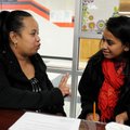 Mandy Ritok, Marshallese liaison for the Springdale School District, talks Wednesday with Ancelitha ...