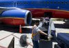 A ground crew worker loads a Southwest Airlines Co. plane in San Diego last spring. The airline said Thursday that its average fare climbed almost $8 in the fourth-quarter compared with a year ago. 