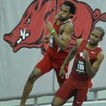 NWA Media/MICHAEL WOODS --01/25/2013-- Arkansas runner Akheem Gauntlett (front) and Nebraska runner ...
