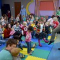Caitlyn Walsh leads children Thursday in a game of “Hokey Pokey” between reading stories during Todd...