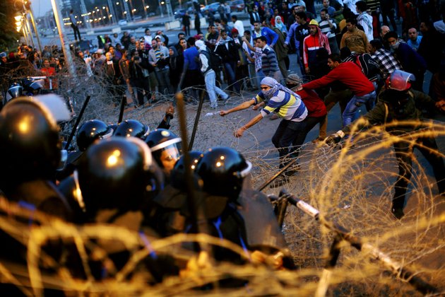 egyptian-protesters-pull-barbed-wires-during-a-protest-in-front-of-the-presidential-palace-in-cairo-egypt-friday-jan-25-2013