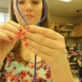 Ashlee Smith concentrates on her knot-tying Thursday during outdoor education class at Rogers High S...