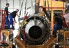 Workers assemble an engine on an Airbus SAS A320 airplane at the company’s plant in Tianjin, China, in June. China is investing heavily in expanding its civilian and military aerospace manufacturing in Tianjin. 