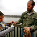 Kevin Bennoch pours water and plankton samples Friday into a container held by Owl Creek School fift...