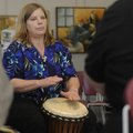 Pam Harris, with Drum Spirit women’s drum circle, plays a djembe drum during the opening of the 2012...
