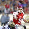 South quarterback Tyler Wilson of Arkansas gets his pass off as North defender Kawann Short of Purdu...