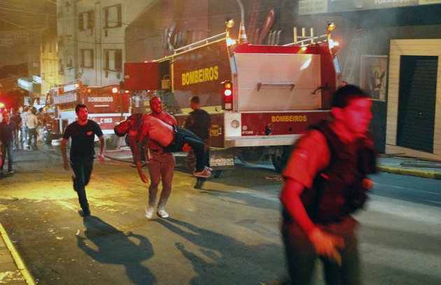 a-man-carries-an-injured-victim-of-a-fire-at-the-kiss-club-in-santa-maria-city-rio-grande-do-sul-state-brazil-early-sunday-jan-27-2013-firefighters-say-that-the-death-toll-from-a-fire-that-swept-through-a-crowded-nightclub-in-southern-brazil-has-risen-to-180-officials-say-the-fire-broke-out-while-a-band-was-performing-at-least-200-people-ere-also-injured
