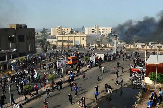 egyptian-protesters-clash-with-police-unseen-in-port-said-egypt-sunday-jan-27-2013-violence-erupted-briefly-when-some-in-the-crowd-fired-guns-and-police-responded-with-volleys-of-tear-gas-witnesses-said-state-television-reported-110-were-injured-egyptian-health-officials-say-3-have-been-killed-in-clashes-between-protesters-and-police-in-port-said