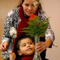 Carminda Gomez helps son, Pablo Gomez, 3, piece together a flower arrangement Saturday at the Spring...