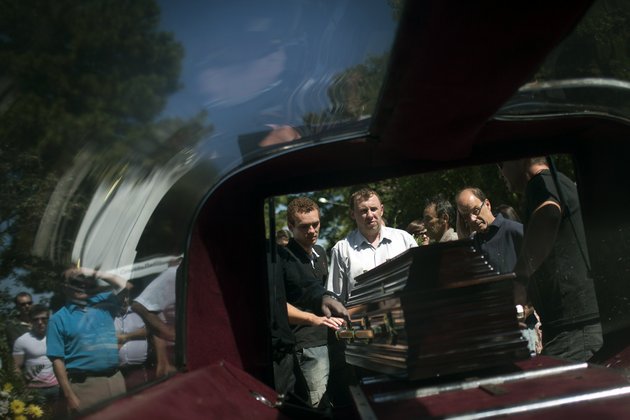 relatives-and-friends-remove-from-a-hearse-the-coffin-carrying-the-remains-of-a-person-who-died-in-a-nightclub-fire-as-they-arrive-to-a-cemetery-for-burials-in-santa-maria-brazil-on-monday-jan-28-2013-a-fast-moving-fire-roared-through-the-crowded-windowless-kiss-nightclub-in-this-southern-brazilian-city-early-sunday-killing-more-than-230-people-many-of-the-victims-were-under-20-years-old-including-some-minors