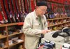 Ron Brown rings up a sale earlier this month for a customer who bought several ammunition magazines for AR-15 and AK-47 assault rifles at Don’s Weaponry in North Little Rock. 