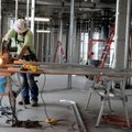 Josh Rainey with Dewitt Construction of Springfield, Mo., cuts a metal beam to build a wall Monday a...