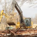 Nehemiah Looper, a worker with the Washington County Road Department, operates a track hoe Monday to...