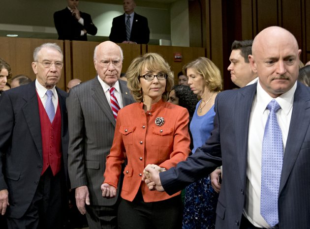 former-arizona-rep-gabrielle-giffords-who-was-seriously-injured-in-the-mass-shooting-that-killed-six-people-in-tucson-ariz-two-years-ago-center-arrives-on-capitol-hill-in-washington-on-wednesday-jan-30-2013-to-speak-before-the-senate-judiciary-committee-hearing-on-what-lawmakers-should-do-to-curb-gun-violence-in-the-wake-of-last-months-shooting-rampage-at-that-killed-20-schoolchildren-in-newtown-conn-from-left-are-the-committees-ranking-republican-sen-charles-grassley-r-iowa-committee-chairman-sen-patrick-j-leahy-d-vt-and-her-husband-mark-kelly-a-retired-astronaut-giffords-right
