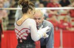NWA Media/ANDY SHUPE -- Arkansas co-head coach Mark Cook speaks to senior Amy Borsellino before her performance on the bars during a meet with Georgia Friday, Jan. 11, 2013, in Barnhil Arena on the UA campus in Fayetteville.