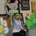 Megan James with Trike Theater hoists a cardboard chicken Wednesday for children at the Rogers Publi...