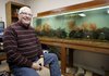 Denny Rogers sits in his favorite personal space, one of the aquarium rooms he has set up at his home near Beaver Lake.