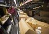 United Parcel Service Inc. employees move packages at a sorting facility in San Francisco on Dec. 20. The company said Thursday that it lost $1.75 billion in the fourth quarter. 