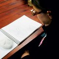 Danielle Schaal, 15, works on drawings of a sand biscuit in Dawn Graham’s art class at Har-Ber High ...