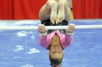 NWA Media/MICHAEL WOODS --02/01/2013-- University of Arkansas gymnast Erin Freier does a flip on the bars during Friday night's meet against Florida at Barnhill Arena in Fayetteville.